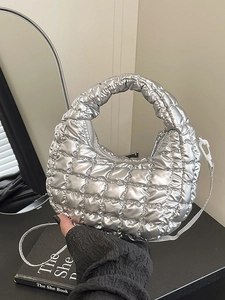Chic silver quilted half-moon handbag with a metallic finish and adjustable strap