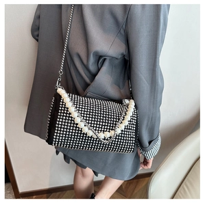 Detail of silver rhinestone Boston bag with pearl handle and metal chain strap
