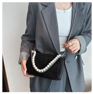 Close-up of black rhinestone Boston bag with pearl handle and silver chain strap