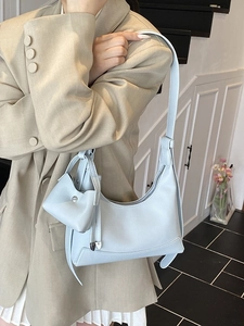 Light blue pebbled leather underarm shoulder bag with a mini coin purse pendant for women