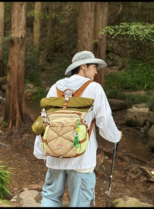 Close-up of waterproof roll-top hiking backpack with elastic cord storage and buckle detail