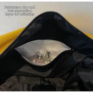 Detail view of yellow travel bag featuring a black lining and dry-wet separation pocket