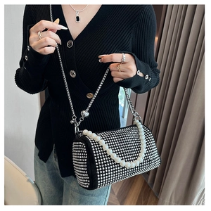 Detail of Boston bag with silver rhinestones, pearl chain handle, and metallic crossbody strap