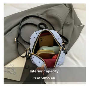 Internal capacity of mini striped backpack with heart pattern and burgundy lining detail