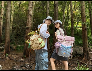 Detail of roll-top outdoor hiking backpack with elastic cord and mesh pocket in nature