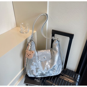 Silver metallic shoulder bag with cloud pleats and brown teddy bear charm detail