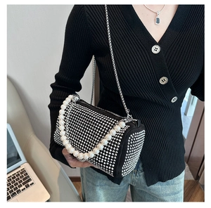 Detail of black Boston bag with sparkling rhinestones and white pearl handle