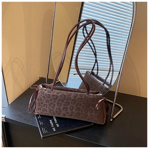 Close-up of leopard print shoulder bag with sleek brown straps and retro matte texture