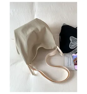Detailed top view of a beige hobo bag in nylon material with wide shoulder strap