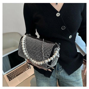 Detail of black Boston bag with sparkling silver rhinestones and pearl handle strap