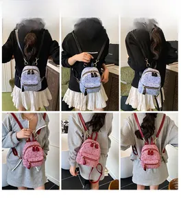 Detail shots of mini polka dot corduroy backpacks in blue and rose red on a model