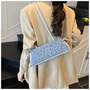 Light blue leopard print shoulder bag detail with stylish side drawstring accents