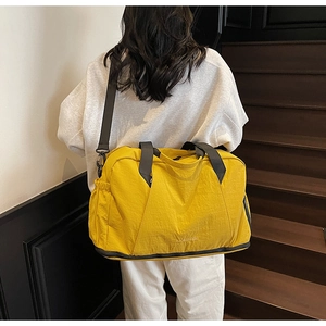Macro shot of yellow fitness bag with waterproof nylon texture and dry-wet separation pocket