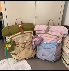 Detail of roll-top outdoor backpacks featuring mesh pockets and elastic bungee cords