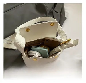 Top view of open white faux leather bag showing spacious interior with zip pocket