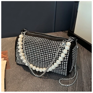 Detail of silver rhinestones and white pearl chain on black cylinder Boston bag
