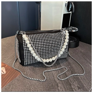 Detailed close-up of a luxury Boston bag with silver rhinestones and a pearl handle
