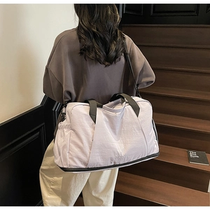 Detail of light purple fitness bag showing the bottom wet/dry compartment on stairs