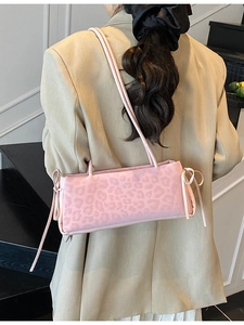 Chic pink leopard print baguette shoulder bag with stylish decorative side bows