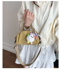 Detail of Mustard Yellow Nylon Crossbody Bag with Plush Keychain and Top Handles