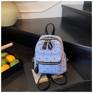 Detailed macro view of the blue and white striped mini backpack with black heart prints