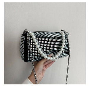 Detail of Boston bag featuring iridescent rhinestones and elegant faux pearl handle