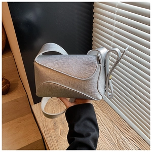 Detail of silver lychee texture leather bag with asymmetrical geometric design
