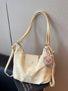 Minimalist light yellow PU leather tote bag with long strap and brown bear charm