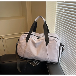 Lavender waterproof fitness bag on a leather sofa featuring black canvas straps and a logo