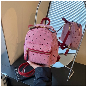 Detailed mirror view of mini striped backpack with heart prints and red shoulder straps