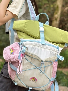 Outdoor color-block backpack for women in green and white with a small pink coin purse