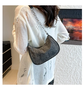 Detail showing the crescent denim bag with sparkling sequins and silver chain strap