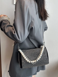 Fashionable black Boston bag with sparkling rhinestones and elegant pearl chain