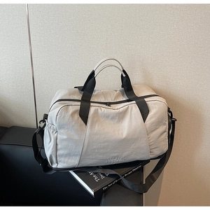 Detail view of large fitness travel bag with durable straps and side storage pocket
