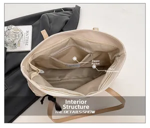 Detail view of large tote bag interior featuring zipper pocket and spacious main compartment