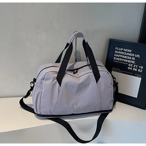 Detail view of large lavender travel bag showing shoe compartment and durable nylon fabric