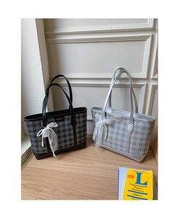 Detail of plaid tote bags in black and silver with lace bow and pearl charms