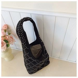 Dettaglio borsa hobo in pelle scamosciata nera con borchie argento e tasca interna