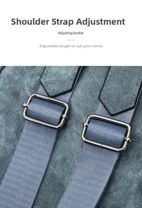 Detail view of the adjustable blue nylon strap and matte grey metal buckle on the backpack
