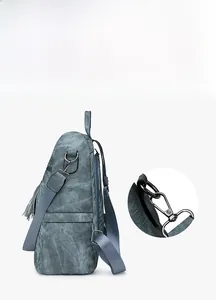 Detail of detachable silver metal hook and adjustable fabric strap on women's backpack