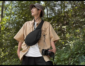 Close-up of black crossbody bag made of durable nylon fabric for outdoor travel use