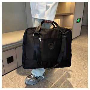 Waterproof black nylon travel bag with large capacity, dual handles and shoulder strap