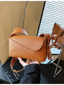 Brown litchi grain leather crossbody square bag with minimalist flap design and wide strap