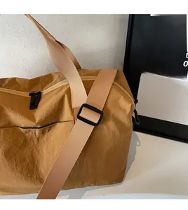 Detail of adjustable shoulder strap and durable fabric on travel duffel bag