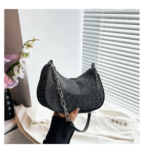 Detail of black denim hobo bag with rhinestone studs and chunky silver metal chain
