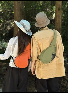 Outdoor leisure chest bag with side mesh pocket and wide brim sun hat in forest setting