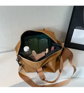 Spacious interior of khaki nylon travel bag showing organized storage for gadgets