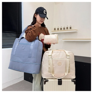 Detail view of large travel tote set in blue and beige waterproof nylon with organizer pouch