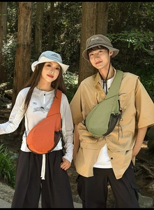 Detail of outdoor oxford fabric crossbody bag and matching bucket hat with side mesh pocket