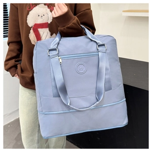 Close-up of water-resistant light blue travel tote bag with durable nylon texture